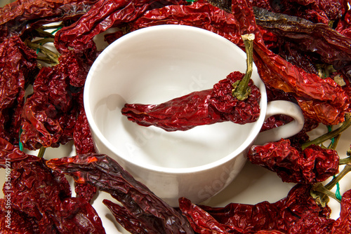 Closeup of peperoni cruschi, an air-dried crunchy sweet pepper used in the cuisine of Basilicata in Italy. Typical product of Lucan cuisine on white background. photo