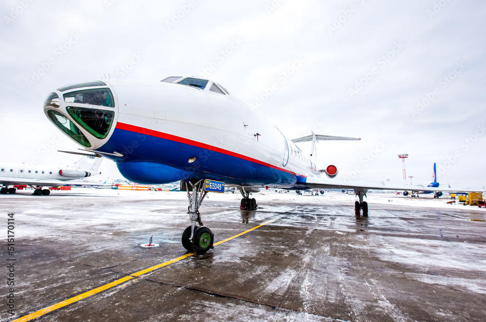 Naklejka premium Airplane front fuselage with blue sky. Aircraft on runway of airfield