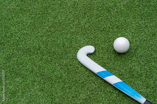iField hockey stick and ball on green grass. Horizontal sport theme poster, greeting cards, headers, website and app.