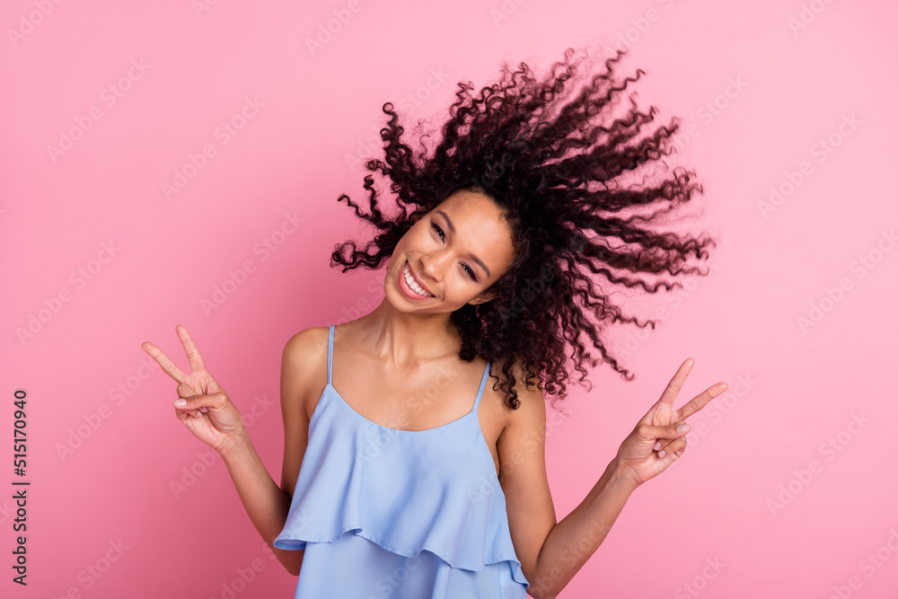 Photo of pretty positive lady toothy smile two hands fingers demonstrate v-sign isolated on pink color background