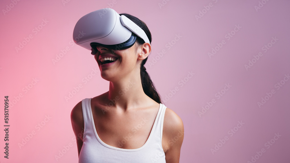 Cheerful young woman having fun in virtual reality Cheerful young woman having fun in virtual reality