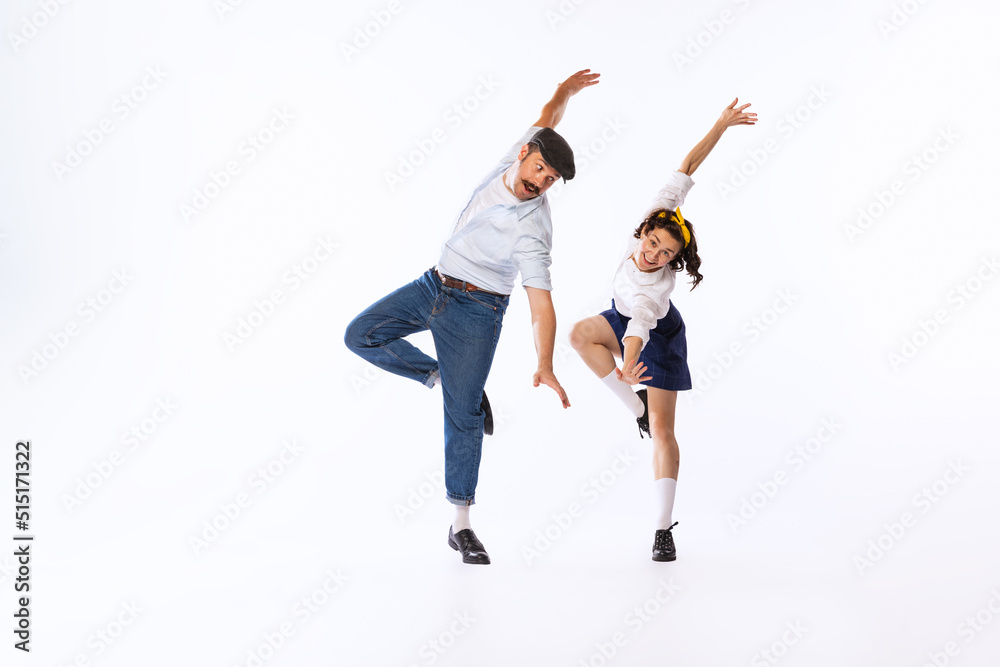Portrait of beautiful couple, man and woman, dancing isolated over white studio background. Retro party Portrait of beautiful couple, man and woman, dancing isolated over white studio background. Retro party