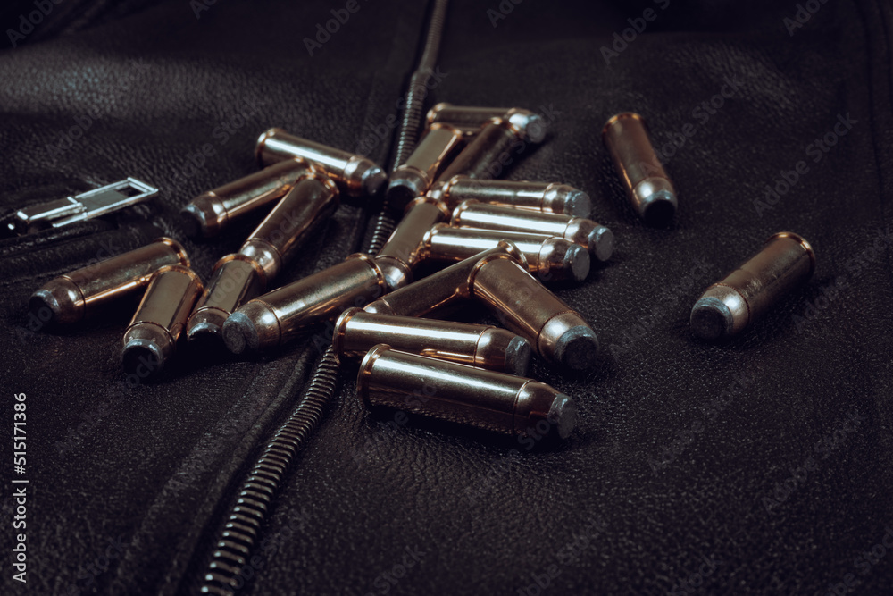 .44 magnum revolver ammunition on a black leather background (biker jacket) .44 magnum revolver ammunition on a black leather background (biker jacket)