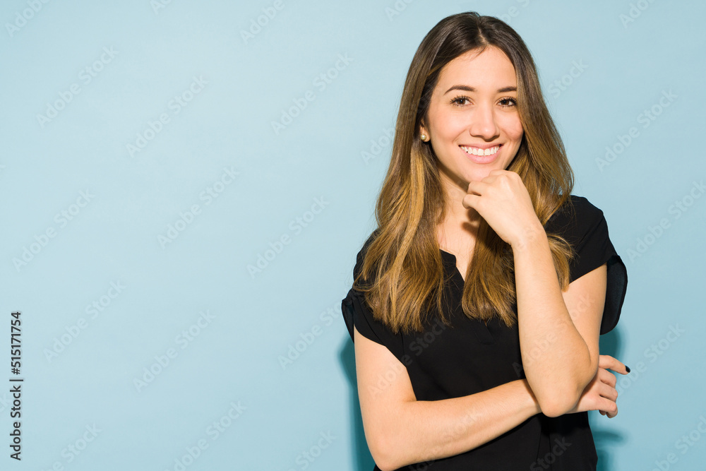 Pretty Caucasian brunette in casual clothing standing in a studio Pretty Caucasian brunette in casual clothing standing in a studio