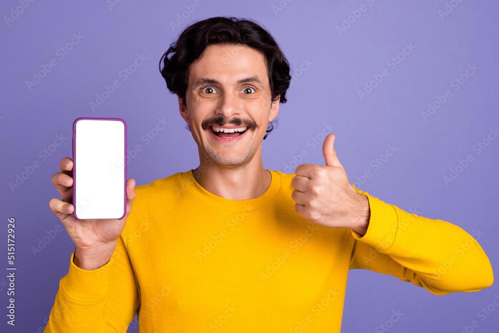 Photo of handsome cheerful guy demonstrate empty space ui menu phone thumb up isolated on violet color background Photo of handsome cheerful guy demonstrate empty space ui menu phone thumb up isolated on violet color background