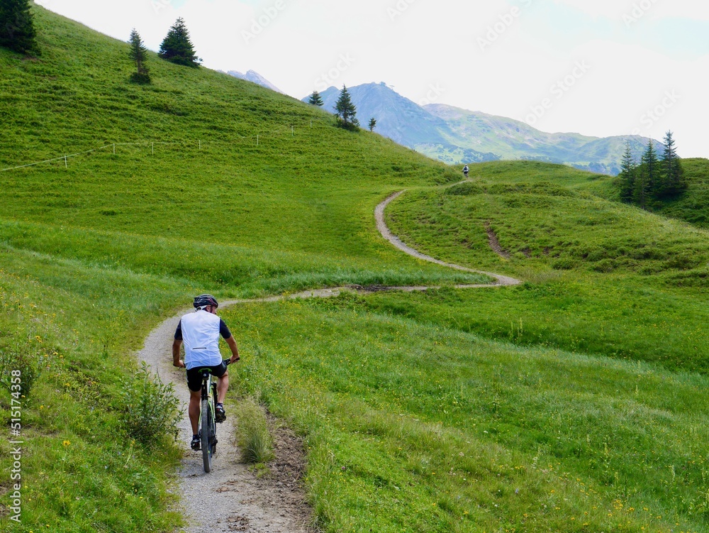 Mountain biking on gravel path in the Austrian Alps. Lech, Arlberg, Austria.