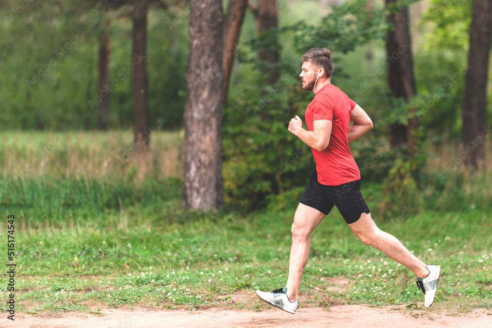 Running man. Male runner jogging at the park. Guy training outdoors. Exercising on forest path. Healthy, fitness, wellness lifestyle. Sport, cardio, workout concept Running man. Male runner jogging at the park. Guy training outdoors. Exercising on forest path. Healthy, fitness, wellness lifestyle. Sport, cardio, workout concept