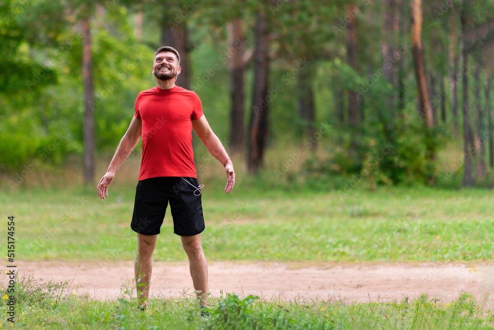 Man runner training. Male athlete stretching muscles at the park. Healthy, fitness, wellness lifestyle. Sport, cardio, workout concept Man runner training. Male athlete stretching muscles at the park. Healthy, fitness, wellness lifestyle. Sport, cardio, workout concept