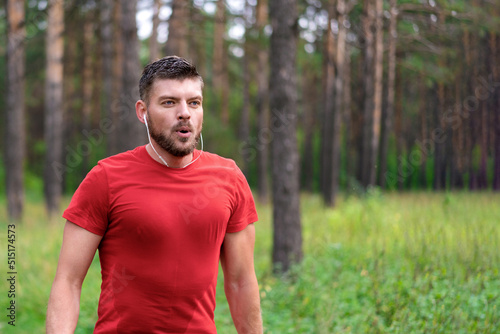 Running man. Male runner jogging at the park. Guy training outdoors. Exercising on forest path. Healthy, fitness, wellness lifestyle. Sport, cardio, workout concept