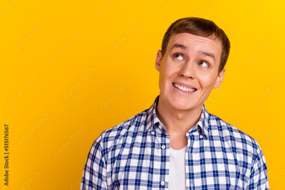 Photo of young handsome guy dream think look empty space isolated over yellow vivid color background Photo of young handsome guy dream think look empty space isolated over yellow vivid color background