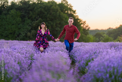 Young couple in a lavender field at sunset