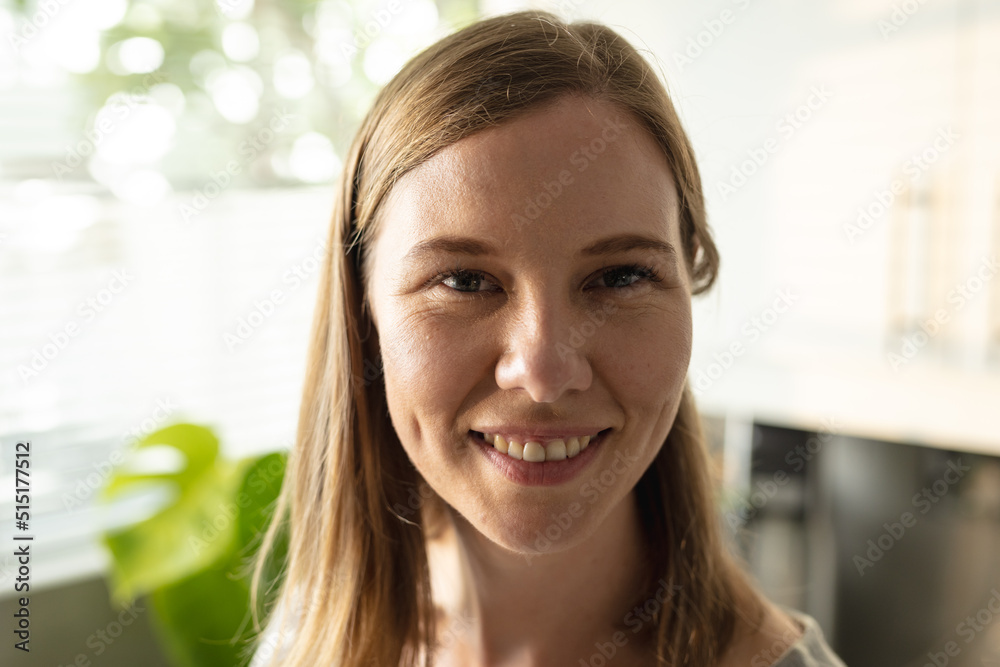 Close-up portrait of smiling caucasian mid adult lesbian woman with blond hair in kitchen Close-up portrait of smiling caucasian mid adult lesbian woman with blond hair in kitchen