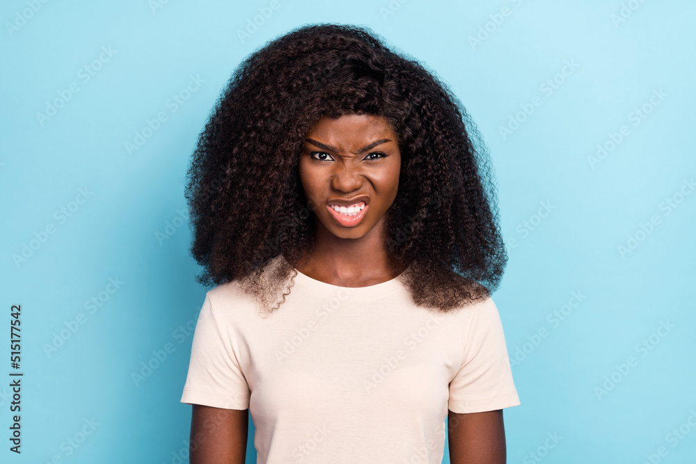 Photo of unsatisfied angry person grin teeth bad mood look camera isolated on blue color background Photo of unsatisfied angry person grin teeth bad mood look camera isolated on blue color background