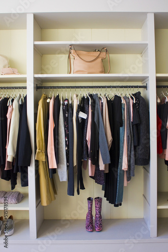 Clothes hang on a shelf in a designer clothes store © Lindasky76