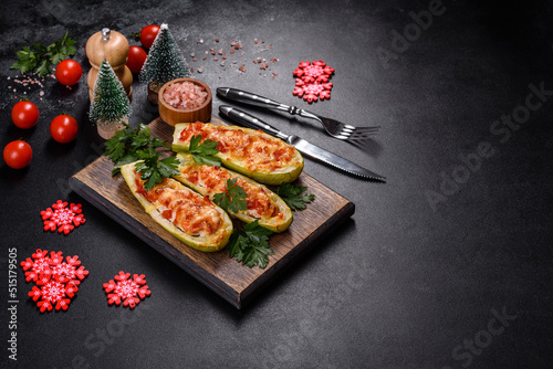Baked stuffed zucchini boats with minced chicken mushrooms and vegetables with cheese. Christmas table © chernikovatv