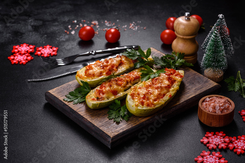 Baked stuffed zucchini boats with minced chicken mushrooms and vegetables with cheese. Christmas table