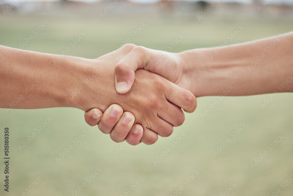 Closeup of two unknown baseball players shaking hands while standing on a grass field. Two sportsmen greeting or congratulating on a good game Closeup of two unknown baseball players shaking hands while standing on a grass field. Two sportsmen greeting or congratulating on a good game