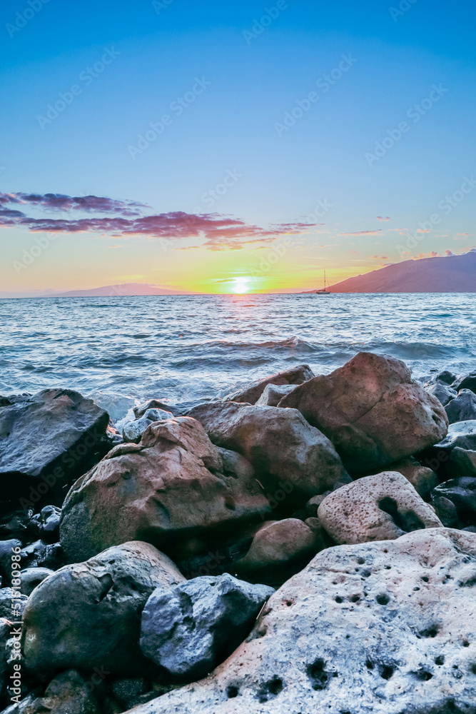 Maui Hawaii beach coastline of sand, sun, and blue water with crashing Maui Hawaii beach coastline of sand, sun, and blue water with crashing