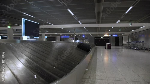 lonely suitcase lie on airport arrival hall carousel being carry from plane to passenger ready to pick up the baggage photo