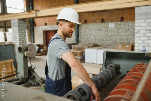 worker in factory on the machine