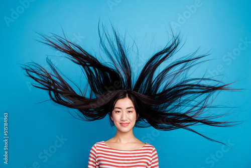 Photo of lovely funny lady dressed red shirt hair flying wind blowing isolated blue color background