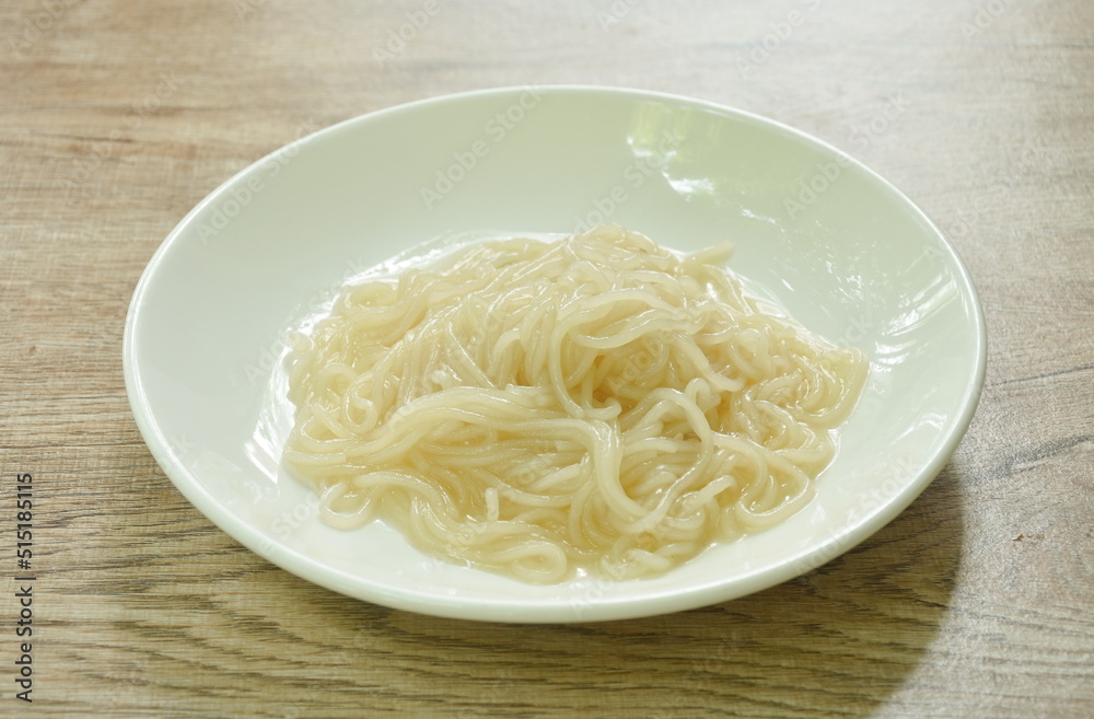 dry Vietnamese rice noodles or Pho with soup on plate dry Vietnamese rice noodles or Pho with soup on plate