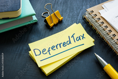 Deferred tax written on the sticker and papers.