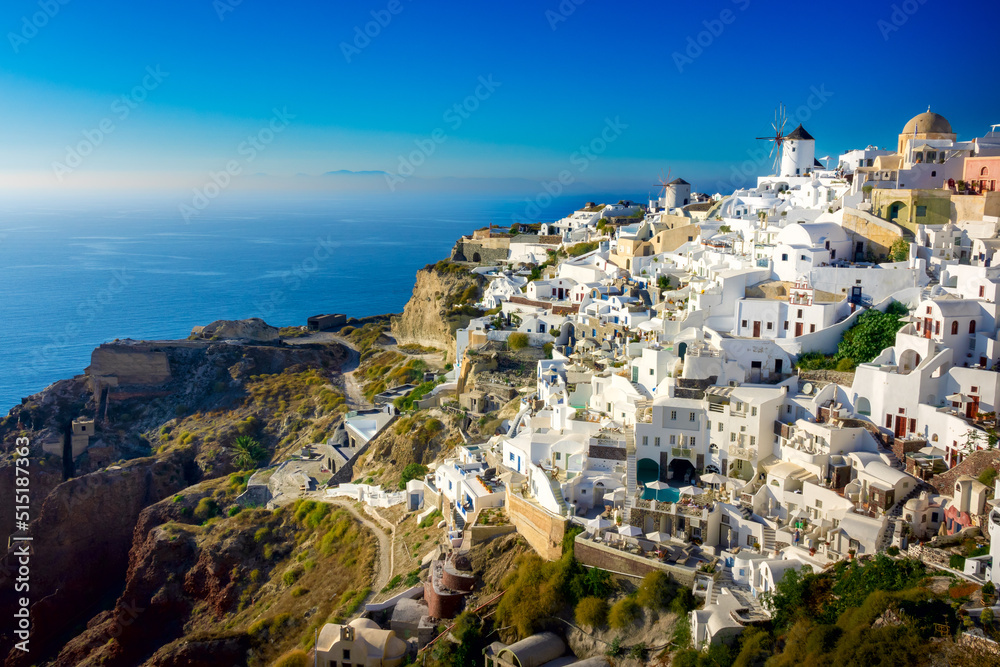Famous Santorini, Greece. Charming view of the village of Oia on the island of Santorini. Traditional famous windmills with and white houses above the caldera in the Aegean.