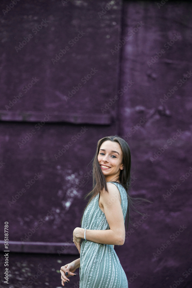 Fototapeta premium A beautiful teen brunette girl with a happy look and looking at the camera