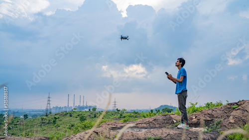 Photography Young man flying drone, unmanned aerial vehicle, photographer, filmmaker or cont