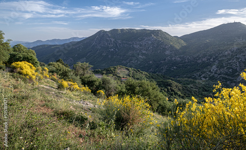 View from a street in Dimitsana, a picturesque mountain village, built like an amphitheatre, surrounded by mountain tops and pine tree forests, Arcadia region, central Peloponnes, Greece