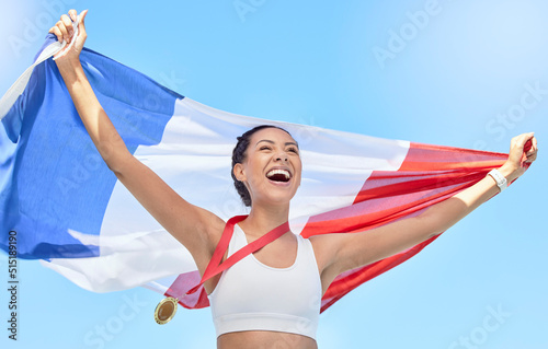 French athlete celebrating her gold medal olympic win, flying a flag. Smiling fit active sporty woman feeling motivated. Celebrating national pride and achieving gold medal in olympic sport