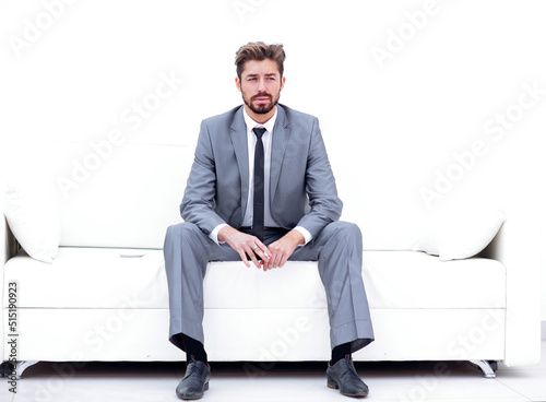 Successful businessman sitting in a suit smokes © ASDF