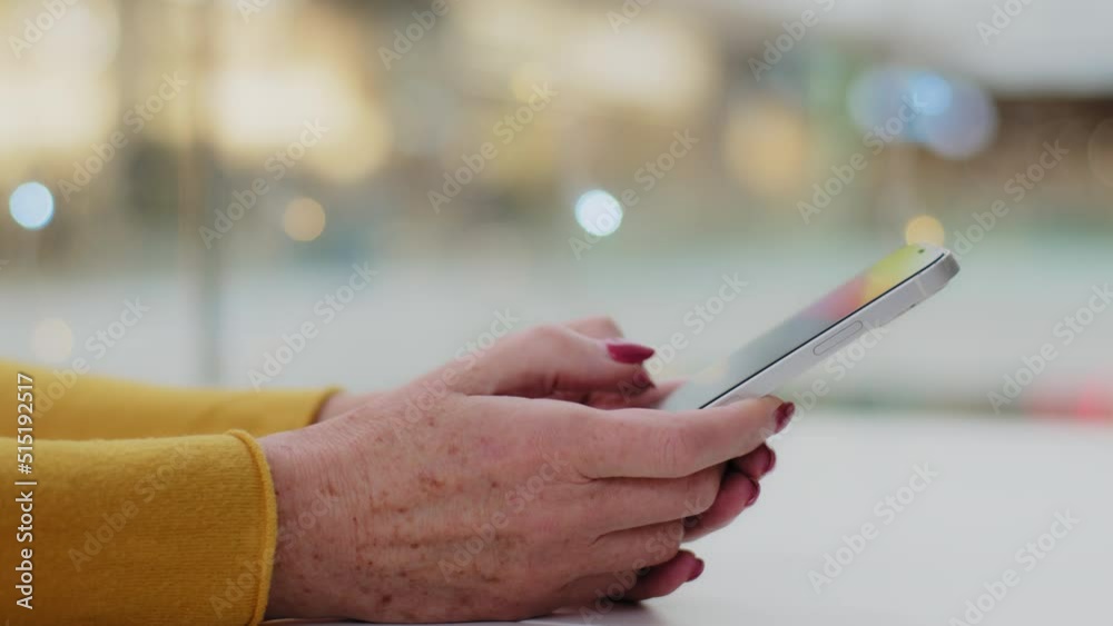 Close-up female hands mature caucasian unrecognizable woman typing on phone middle aged businesswoman checking email writing texting message communicates using mobile application for sms on smartphone Close-up female hands mature caucasian unrecognizable woman typing on phone middle aged businesswoman checking email writing texting message communicates using mobile application for sms on smartphone