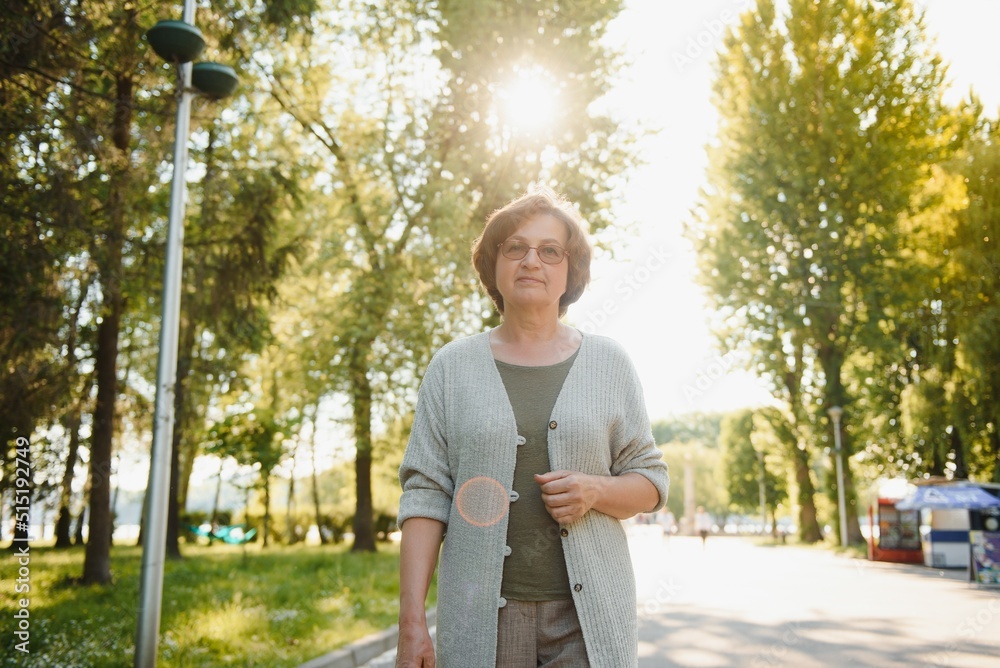 Fototapeta premium Smiling senior woman having recreation in park.