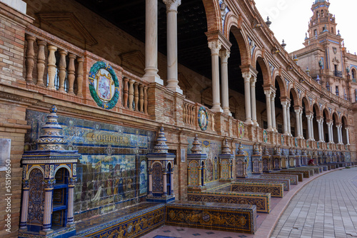 Seville, Spain, September 11, 2021: The Spanish Steps in Seville or Plaza de Espana. The 52 frescos depict all 52 Spanish provinces. The tiles are typical of Andalusia, the so-called azulejos.
