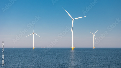 Foto Windmill park in the ocean, drone aerial view of windmill turbines generating green energy electric, windmills isolated at sea in the Netherlands