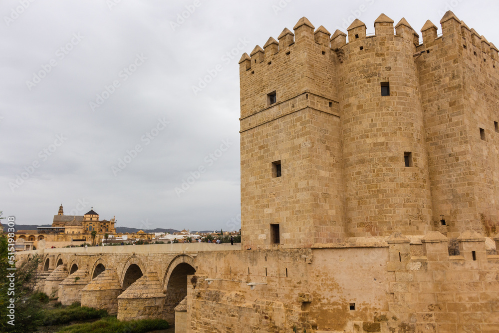 Cordoba, Spain, September 13, 2021: The defensive tower from the Muslim era: the Calahorra Tower, Guadalquivir River, and the Roman Bridge, with Cordoba Mosque-Cathedral in the background.