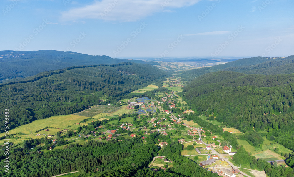 aerial landscape of a village between hills