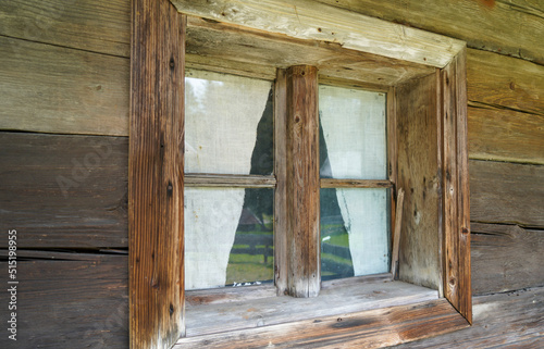 Aged wooden window with glazing and partially weathered in rustic homes