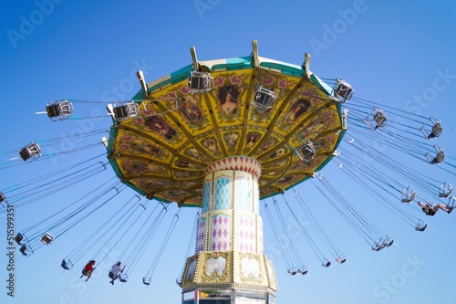 Volgograd, Russian Federation, June 19, 2022 - Swing carousel in an amusement park on the Volga River embankment. 
