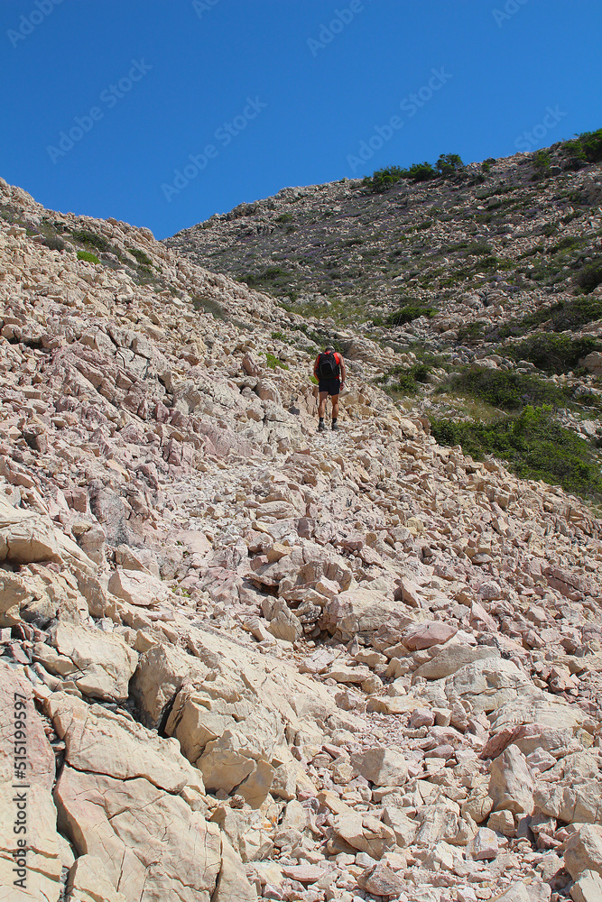 Hiking over stony trails on Krk island, Croatia