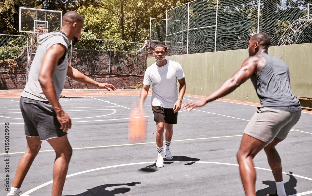 Three african american men playing basketball on a court outdoors. Black man and his sporty friends being athletic outside. Group of basketball players competing in a match or game for recreation fun