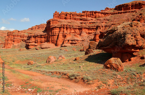 Landscape with red mountains Narman Peribacalari, formed due to erosion and weathering, against the blue sky, near the city of Erzurum, in the region of Eastern Anatolia, Turkey photo