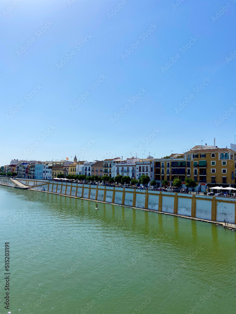 Obraz premium Seville, Spain, September 12, 2021: Situated on the left banks of the Guadalquivir River, Triana is one of the most essential, charismatic, and colorful neighborhoods of the Andalusian city.