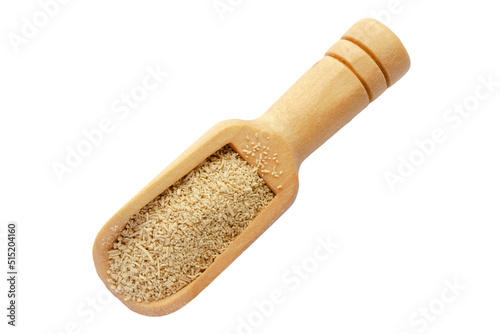 Dry yeast in wooden spoon isolated on white background, top view. Dry granulated yeast in a wooden spoon on a white background, top view. Dry yeast in wooden spoon isolated on white background.