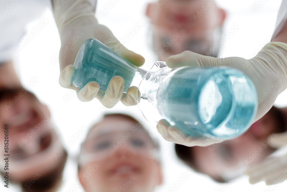image is blurred. beakers in hand, and scientists image is blurred. beakers in hand, and scientists