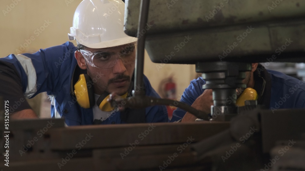 Mechanical engineer adjusting machine in factory. Mechanical engineer adjusting machine in factory.