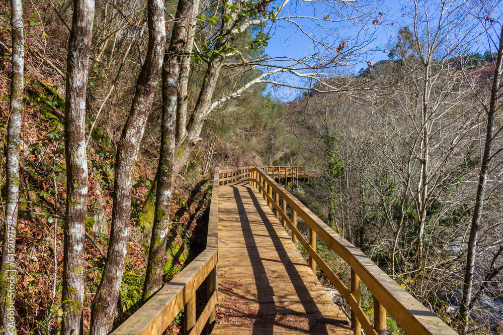 The river hiking trail Ecovia do Vez near Arcos de Valdevez, Portugal. Ecovia do Vez wooden pathways along the riverside. The river hiking trail Ecovia do Vez near Arcos de Valdevez, Portugal. Ecovia do Vez wooden pathways along the riverside.