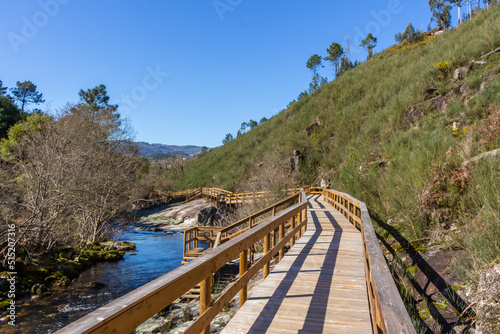 The river hiking trail Ecovia do Vez near Arcos de Valdevez, Portugal. Ecovia do Vez wooden pathways along the riverside.